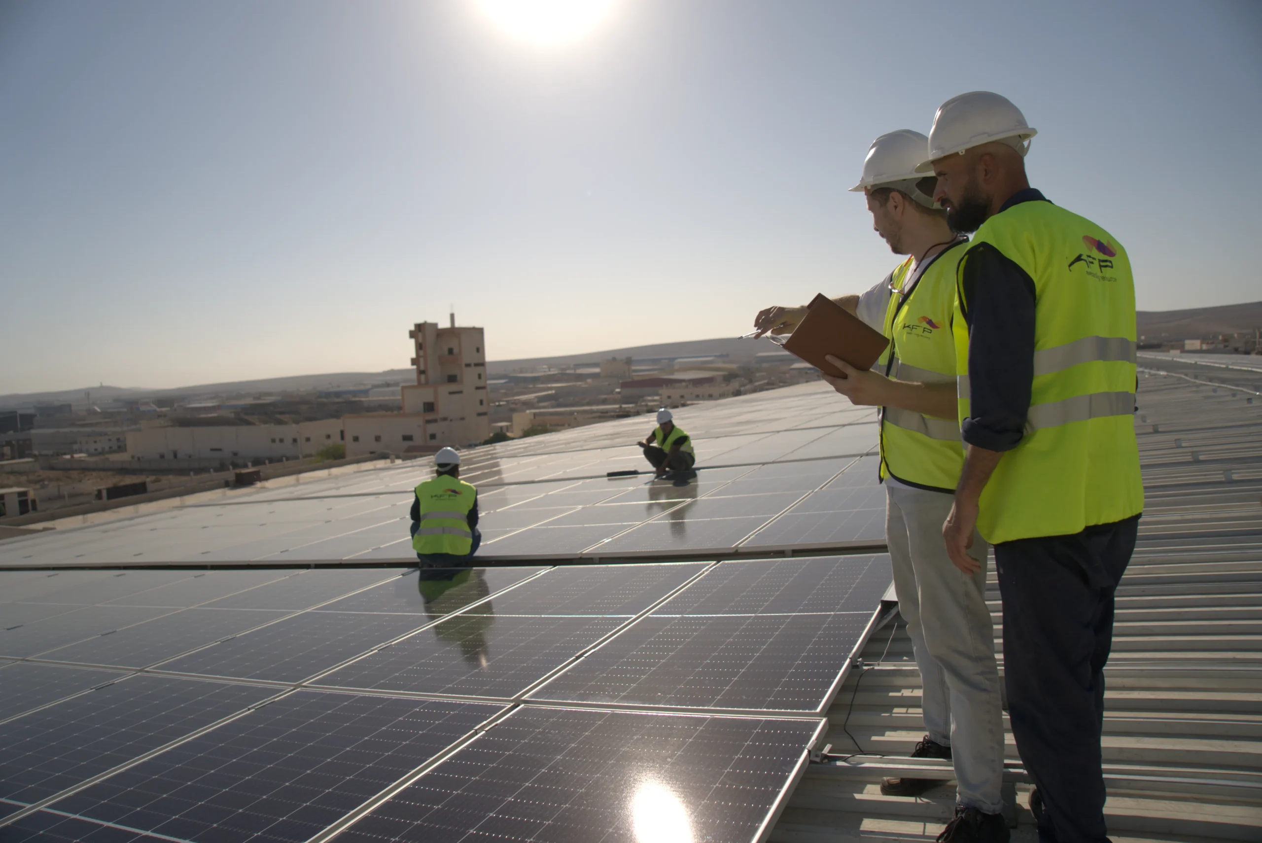 KFP team working on a rooftop solar PV installation