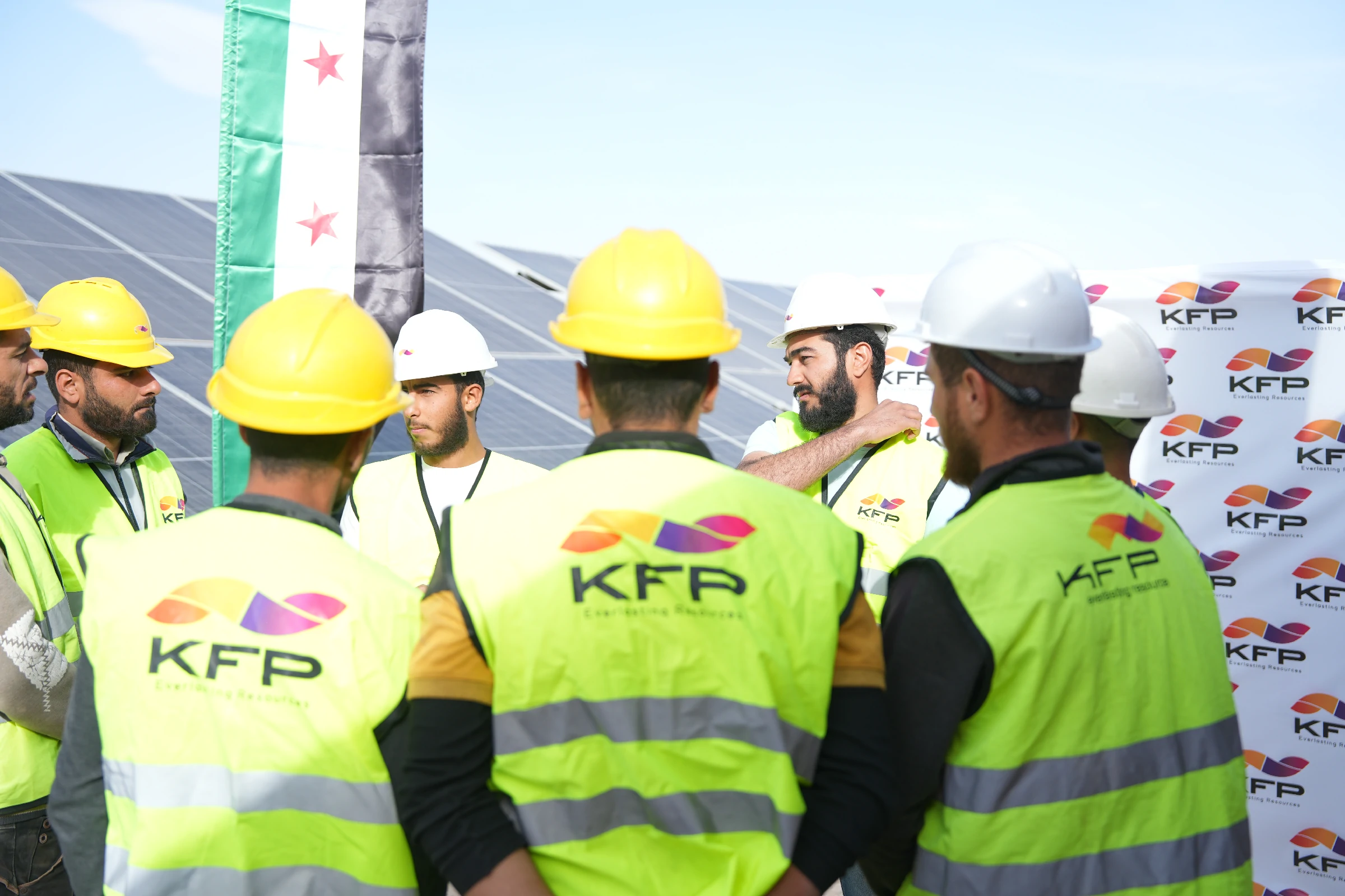 Solar technician working across a rooftop photovoltaic installation