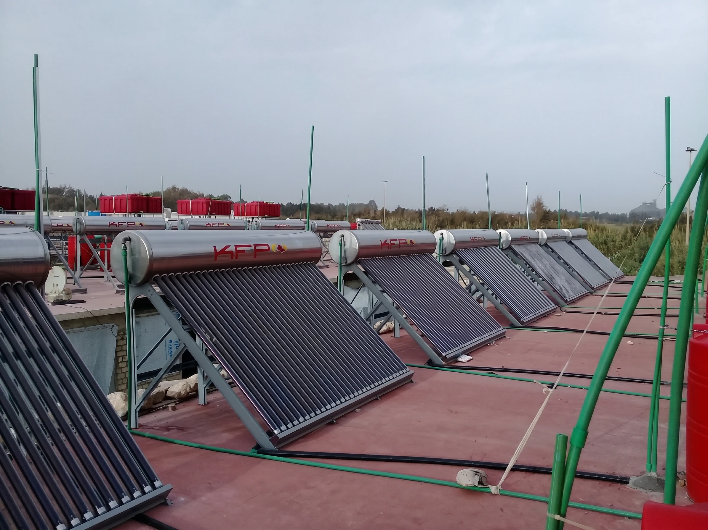 KFP-branded evacuated-tube solar water heaters installed in rows